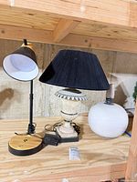 Overall view of three lamps on shelf