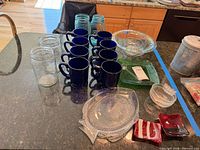 Overview showing mason jars, cobalt mugs, tall glasses, serving dishes