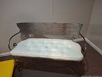 Front view of metal bench with cushion
