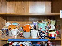 Shelf of assorted mugs—front and back rows