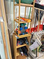 Full view of both shelving units stacked, showing bamboo shelf on top and particleboard bookcase below