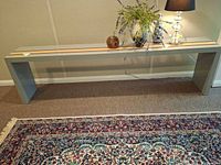 Front view of long grey console table with accent stripes