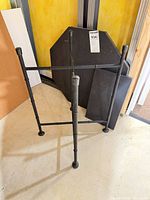 Metal stand with slate-like octagon and rectangle slabs