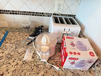 Group view: toaster, juicer, Dash ice cream maker box, electric knife