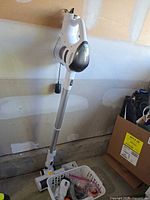 Full view of assembled cordless stick vacuum standing upright