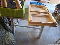 Stool upside down on bench with lap tray parts visible