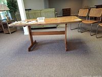 Full view of rectangular table with trestle base
