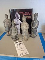 Group view of five figurines with book