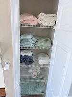 Closet shelves with assorted bath towels on four tiers