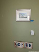 GO HIKE sign and framed bird print on wall