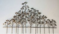 Full frontal view of metal tree branch sculpture on wall