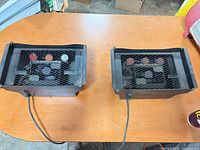 Both American DJ stage lights showing cords and mesh fronts