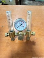 Front view of regulator showing twin flowmeters, gauge and brass body
