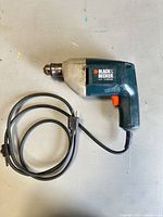 Entire drill with cord visible