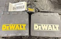 Overall lot showing two DeWalt cases, charger, manuals