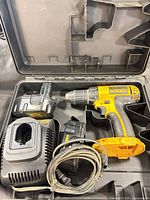 open case showing drill, batteries and charger
