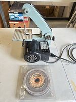 Belt sander front view with spare grinding wheel