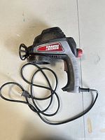 Full view of Krause & Becker paint spray gun with cord visible