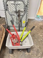 All four items in cart: two loppers, lantern, plastic cart