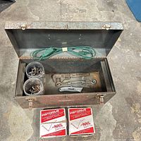 Open metal toolbox with extension cord, plastic cups of hardware, hand tools, two Pistorius V-Nail boxes
