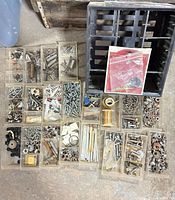 overview of organizer frame with trays of mixed hardware and clock parts