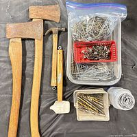 Group shot of axes, hammer, mallet, drill bits, hardware