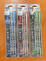 Front view showing three sealed Pilot LED strip light packages in blue, red and green