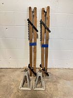 Full view of both jack stands and both scaffold rails leaning against wall