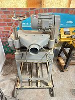 Full view of planer on stand showing dust port and overall condition