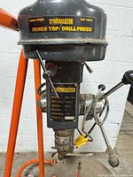 Front view of TradeMASTER drill press head showing brand and general condition