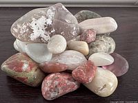 Stack of mixed tumbled stones showing variety of colors and translucency