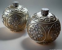 Front angled view of both large illuminated ornaments showing scroll and crystal detailing