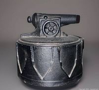 Front view of cast iron trinket box with cannon lid