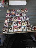 Front view of roughly 36 assorted 1990s hockey cards laid out on table