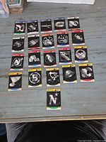 Fronts of 21 Pro Set NHL team logo cards laid out in four rows on table