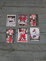 Seven Carey Price hockey trading cards laid out on surface; shows card fronts and protective sleeves