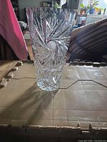 full view of clear cut crystal vase standing upright