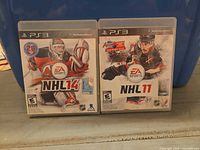 Front view of both PS3 game cases: NHL 14 and NHL 11