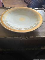 Side profile showing shallow depth and gold trim