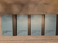 Four teal and black hardcovers front view