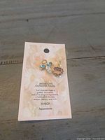Front view of card showing both charms attached
