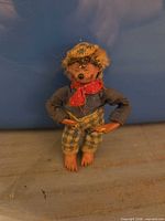 Front view of small bear figurine in clothing