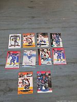 Front view of all 12 Joe Sakic Quebec Nordiques trading cards laid out on table