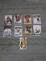 Front view of all 10 hockey cards in sleeves displaying player images and team uniforms