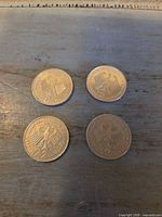Group shot of four 2 DM coins reverse side (eagle and denomination visible)