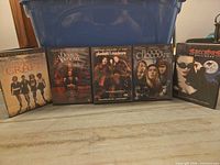 Front view of all five DVD cases standing side by side