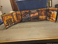 Front view of six DVD cases standing on table