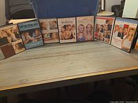 All seven DVD cases lined in a row on table