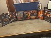 All DVD cases lined up in front of blue bin