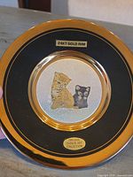 Front view of plate showing full design, gold rim, kittens image